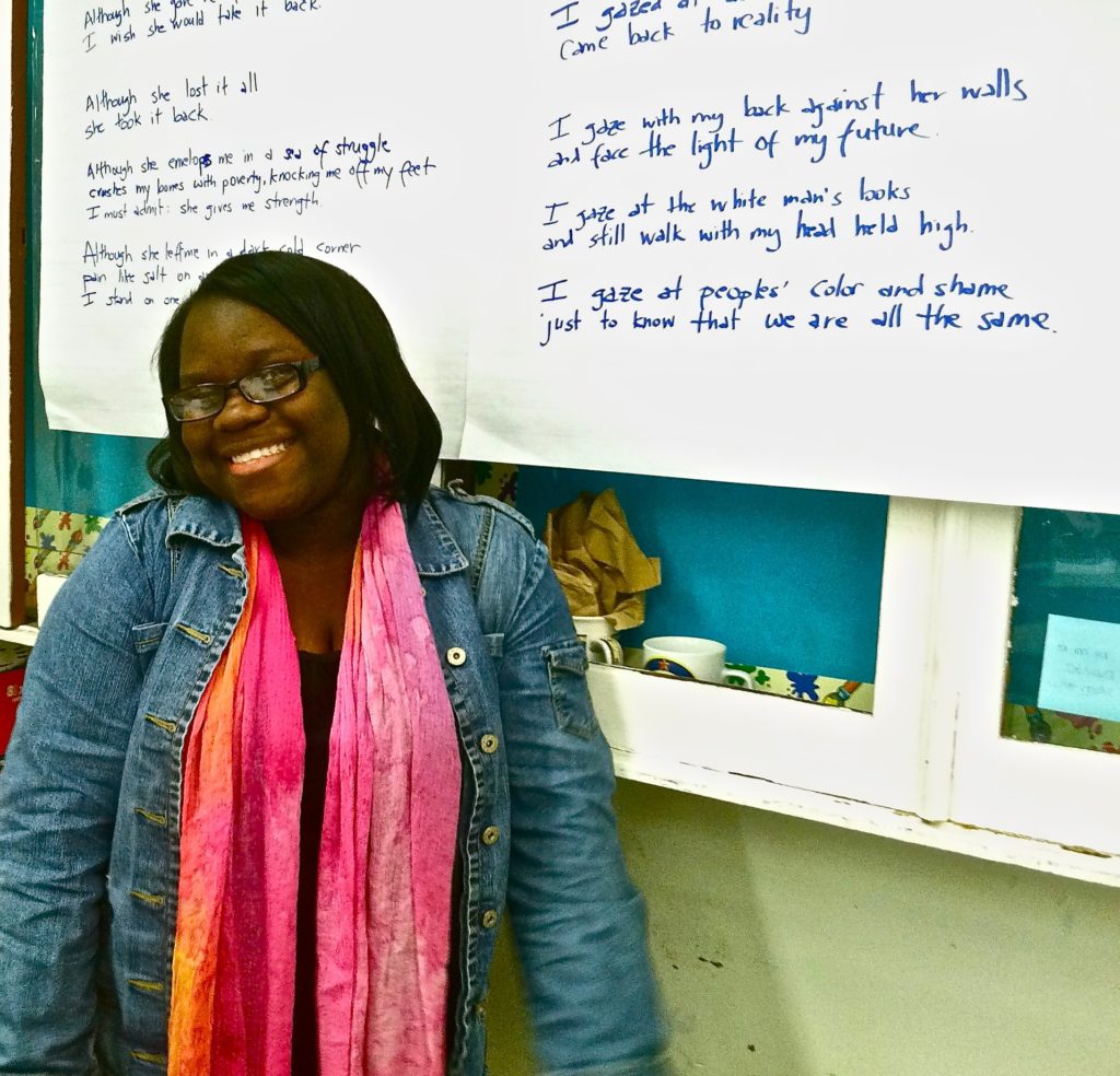 High school student smiling in front of a group poem based on Toni Morrison's Sula